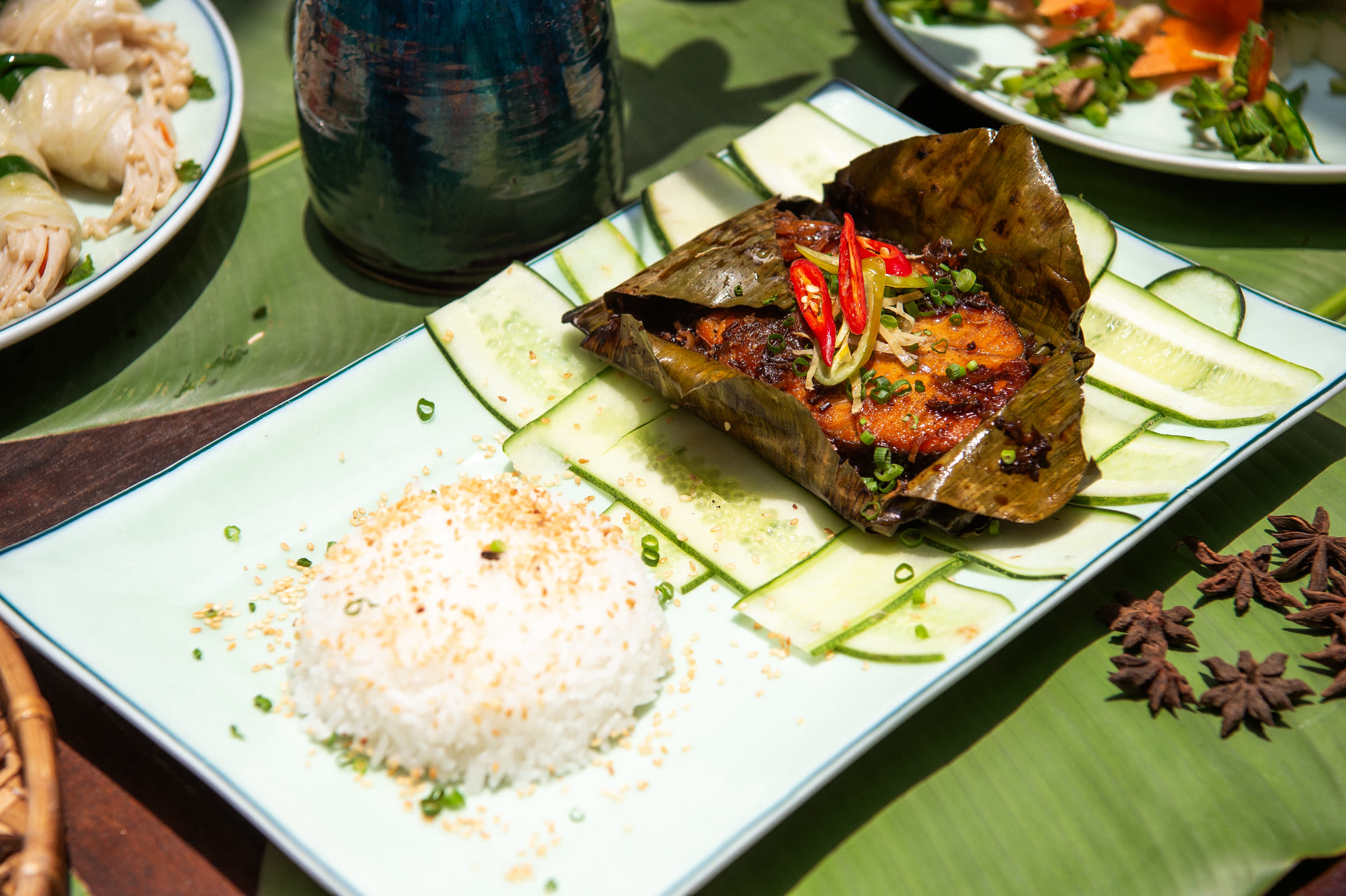 Fish grilled in banana leaf with rice and herbs at Nghê Prana, Hội An