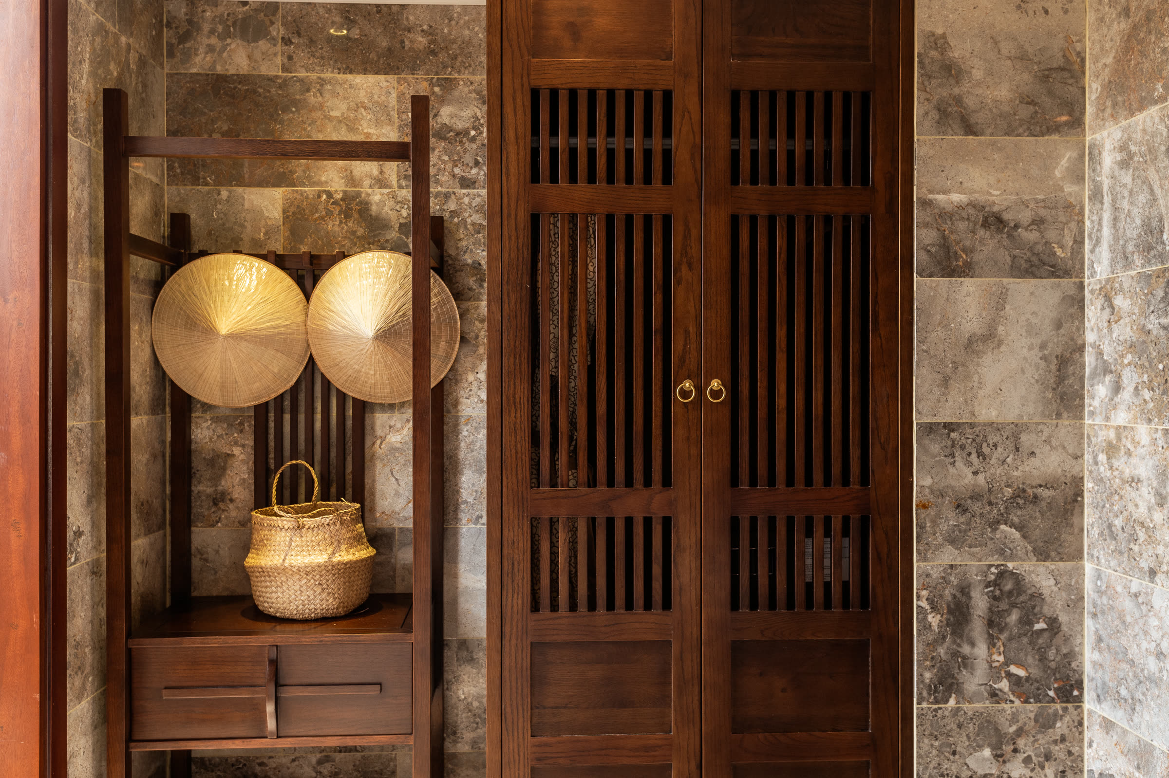 Two conical hats waiting in the wardrobe of a suite at Nghê Prana, Hội An